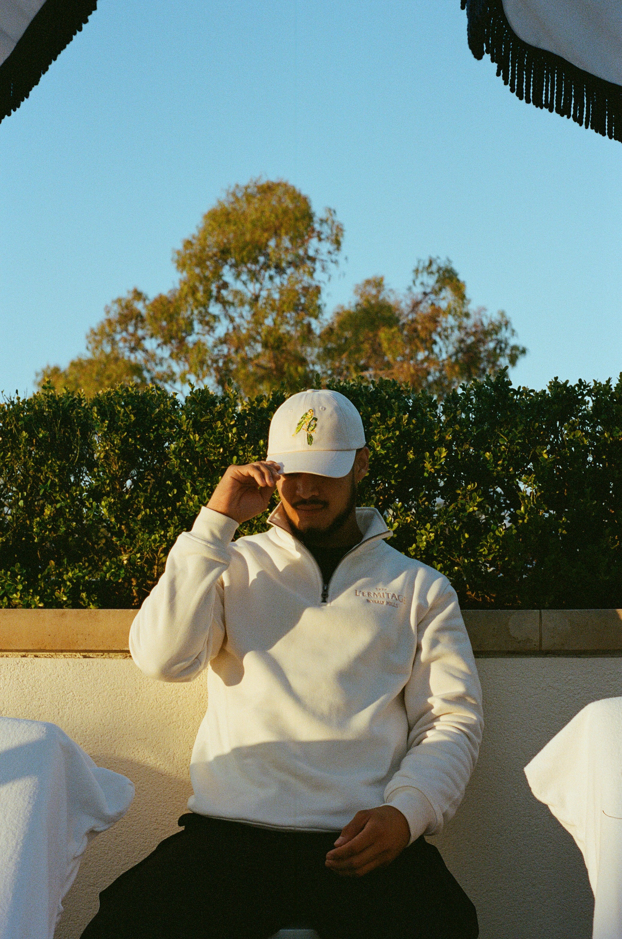 Man wearing the L'Ermitage Beverly Hills x Dinner Service NY dad hat.